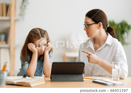 Girl doing homework or online education. 66951397