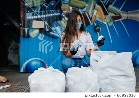 Young woman sorting garbage. Concept of recycling. Zero waste Young woman sorting garbage. Concept of recycling. Zero waste 66952036