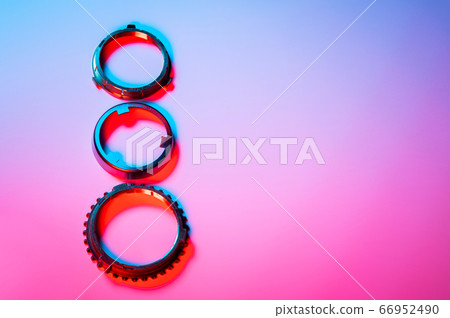 The individual elements of the transmission gear in the gearbox. A new set of synchronizers in brass in blue and red. 66952490