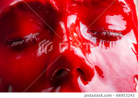Image of a female's face with spreading red paint 66953243