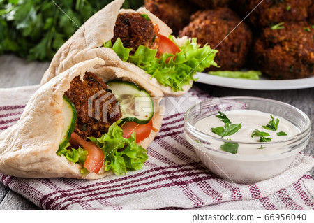 Pita bread with falafel and fresh vegetables Pita bread with falafel and fresh vegetables 66956040