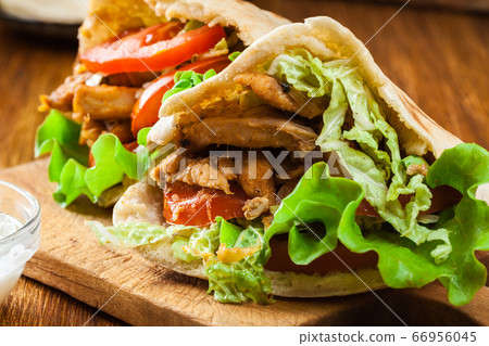 Doner kebab - fried chicken meat with vegetables Doner kebab - fried chicken meat with vegetables 66956045