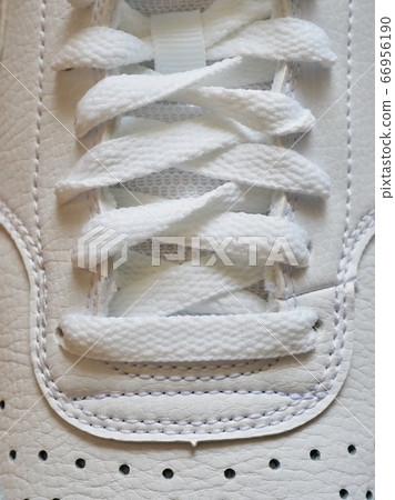 White men's sneakers with wooden board background 66956190