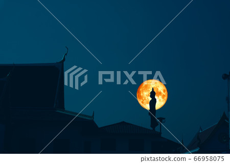 Sunday Buddha and blood moon on night sky in the Sunday Buddha and blood moon on night sky in the 66958075