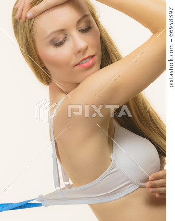 Woman wearing too big bra, loose band Woman wearing too big bra, loose band 66958397