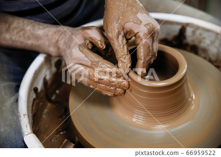Pottery. The master at the potter's wheel, produces a vessel of clay Pottery. The master at the potter's wheel, produces a vessel of clay 66959522