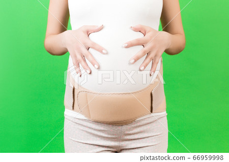 Close up of pregnant woman in elastic pregnancy Close up of pregnant woman in elastic pregnancy 66959998