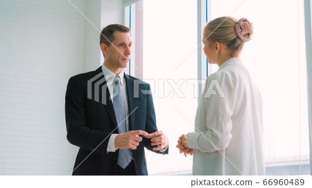Two business people talk project strategy at office Two business people talk project strategy at office 66960489