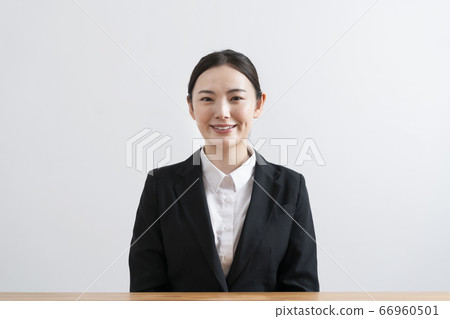Young woman in a suit looking at camera Young woman in a suit looking at camera 66960501