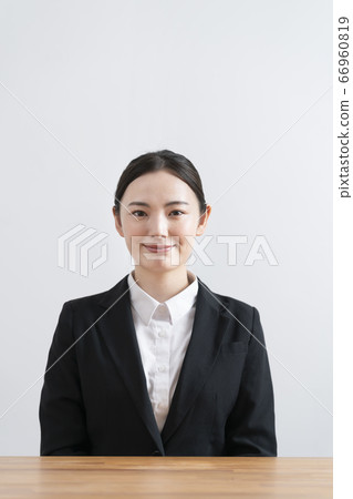 Young woman in a suit looking at camera Young woman in a suit looking at camera 66960819