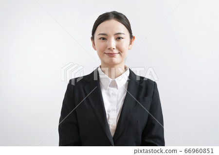 Young woman in a suit looking at camera Young woman in a suit looking at camera 66960851
