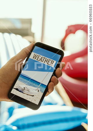 man and text weather in his smartphone man and text weather in his smartphone 66960883