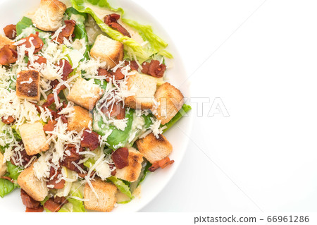 caesar salad on white background 66961286