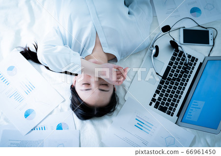 Woman lying in bed tired of telework Woman lying in bed tired of telework 66961450