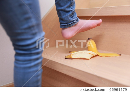 Girl likely to slip on banana skin when climbing up and down the stairs Girl likely to slip on banana skin when climbing up and down the stairs 66961579