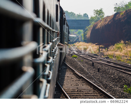 A traditional train carriage in India in transit. A traditional train carriage in India in transit. 66962224