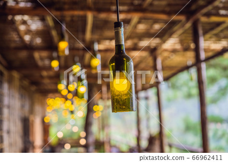 Beautiful retro light lamp decor made of empty wine bottles. Toned 66962411
