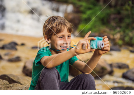 Little photographer taking picture with toy camera Little photographer taking picture with toy camera 66962609