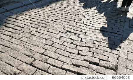 Paving slabs with a shadow from pedestrians on the street of Istanbul. Paving slabs with a shadow from pedestrians on the street of Istanbul. 66964008