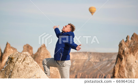 Colorful balloons over volcanic rocks in Cappadocia. Turkey. 66964162