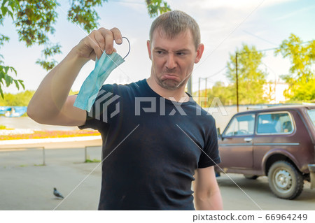 antibacterial medical mask in the hand of a person antibacterial medical mask in the hand of a person 66964249