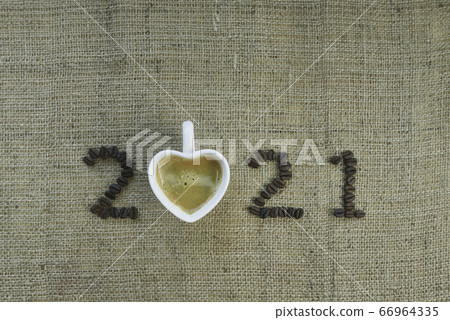 2021 coffee beans and cup of heart shape on sack texture background, New Year concept 66964335