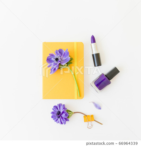 Beauty composition with yellow notebook, anemones and nail polish on white background. Flat lay. Beauty composition with yellow notebook, anemones and nail polish on white background. Flat lay. 66964339