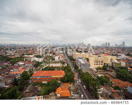 Panorama of the city of Jakarta, the capital of Indonesia, in cloudy weather. 66964735