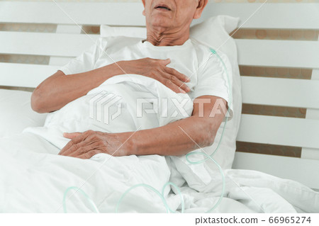 Sad senior man lying on the hospital bed and with Sad senior man lying on the hospital bed and with 66965274
