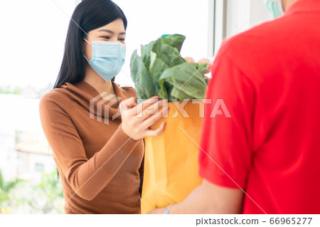 Asian woman wearing a face mask and pickup Asian woman wearing a face mask and pickup 66965277