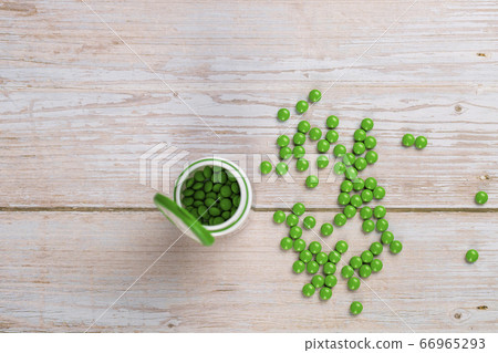 Home therapy. Round green vitamin pills on wooden table Home therapy. Round green vitamin pills on wooden table 66965293