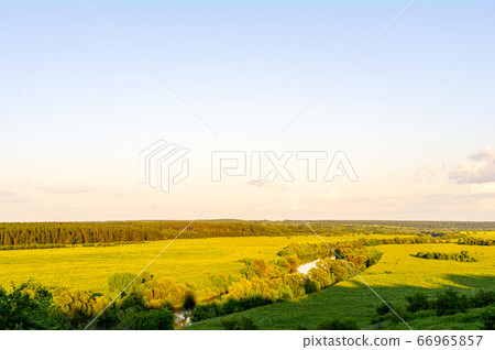 River and fields in the afternoon sun River and fields in the afternoon sun 66965857
