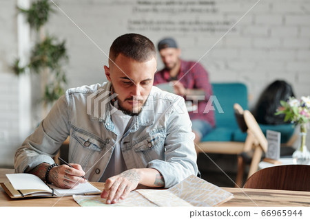 Hipster tourist using paper map Hipster tourist using paper map 66965944