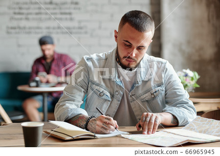 Hipster guy viewing map Hipster guy viewing map 66965945