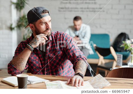 Thinking about trip in cafe Thinking about trip in cafe 66965947
