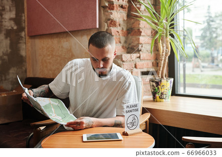 Tourist with map in lounge area Tourist with map in lounge area 66966033