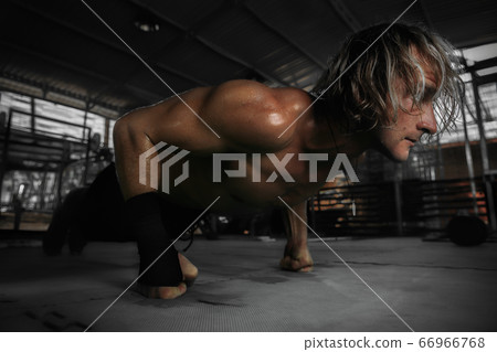 Bodybuilder is pushing up 66966768