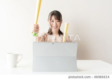 A woman watching sports on a tablet PC 66966814