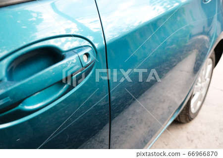 Scratch on a car body close-up. Damage to the paintwork. Scratch on a car body close-up. Damage to the paintwork. 66966870