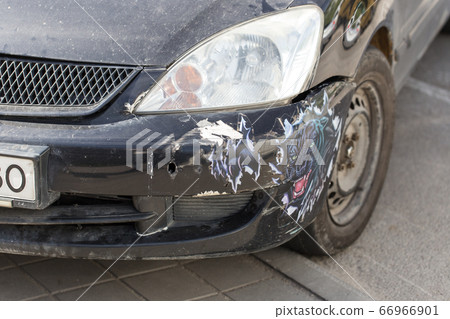 Broken bumper on a black car. Dirty car after an accident. Broken bumper on a black car. Dirty car after an accident. 66966901