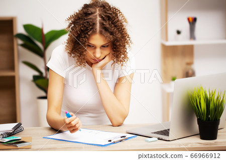 Exhausted business woman working in the office on a laptop 66966912