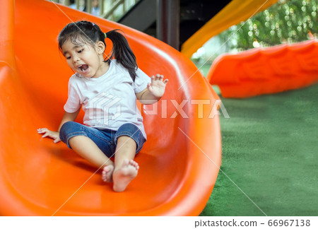 asian Thai girl smile and fun with slider outdoor asian Thai girl smile and fun with slider outdoor 66967138