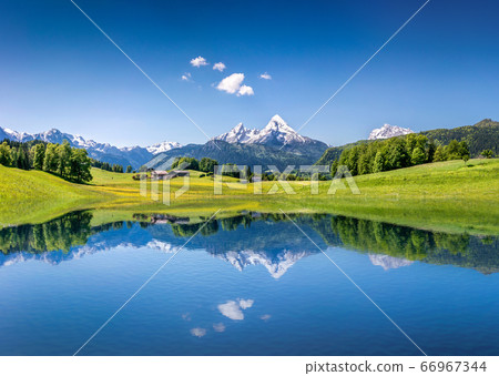 Idyllic alpine summer landscape with tranquil mountain lake in the Alps Idyllic alpine summer landscape with tranquil mountain lake in the Alps 66967344