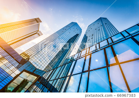 Modern skyscrapers in business district at sunset against blue sky Modern skyscrapers in business district at sunset against blue sky 66967383