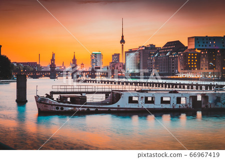 Berlin skyline with old ship wreck in Spree river at sunset, Germany 66967419