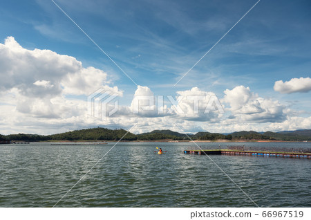 Tourist canoeing on lake in dam with blue sky 66967519