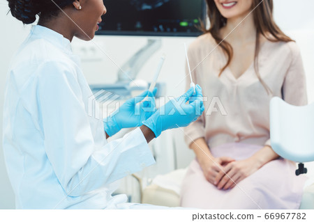 Woman seeing gynecologist doctor to check for STD 66967782