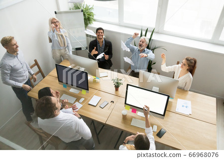 Diverse happy office team launching paper planes together, top v Diverse happy office team launching paper planes together, top v 66968076