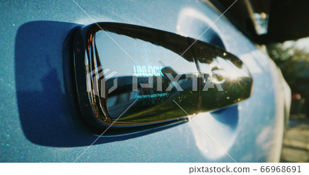 Woman using fingerprint reader on car Woman using fingerprint reader on car 66968691