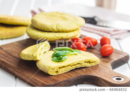 Indian pita bread with green salad and tomato. Indian pita bread with green salad and tomato. 66968832
